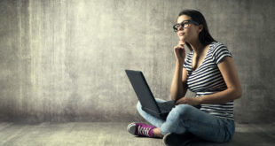 woman at laptop staring into space