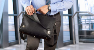businessman closing up briefcase