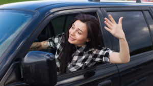 impatient woman gesturing from her car