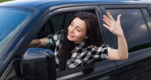 impatient woman gesturing from her car