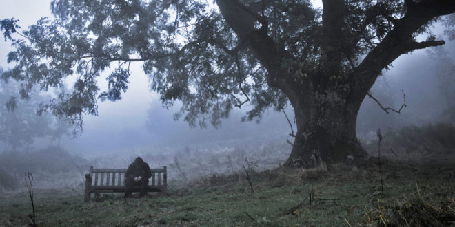 man sitting in foggy and cloudy day