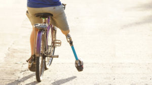 man with leg prosthetic riding bike