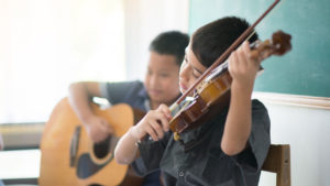 boys playing violin and guitar