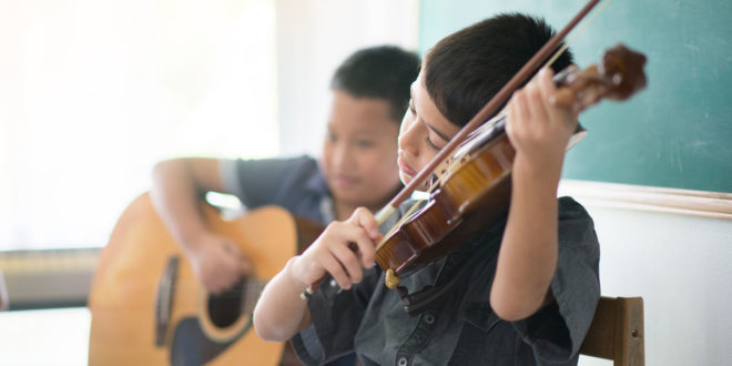 boys playing violin and guitar
