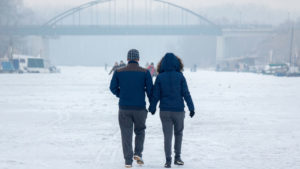 couple walking on snowy street
