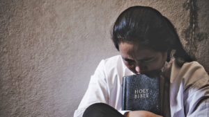 lady praying with Bible