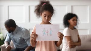 little girl with drawing of family