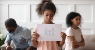 little girl with drawing of family