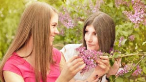 two young women looking at flowers