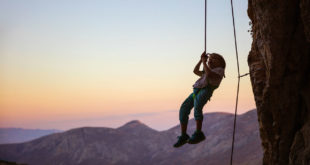 child hanging from rope