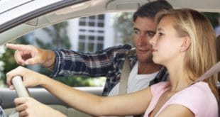 man giving woman driving lessons