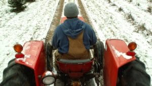Man on tractor in snow