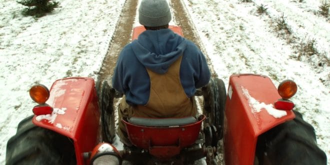 Man on tractor in snow
