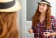 two young women with hats on talking