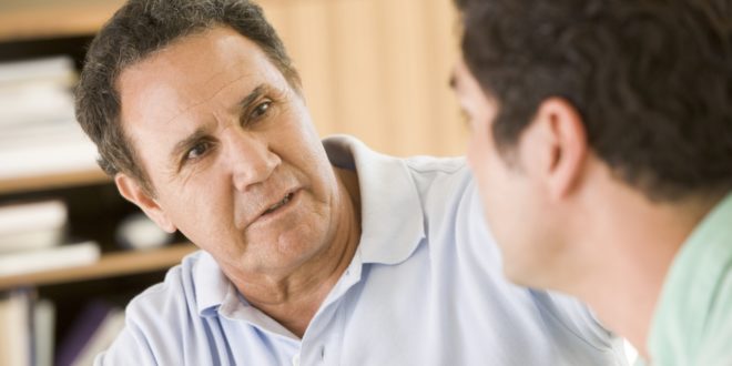 older man talking to younger man