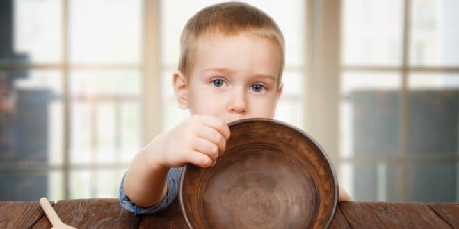little boy showing empty bowl