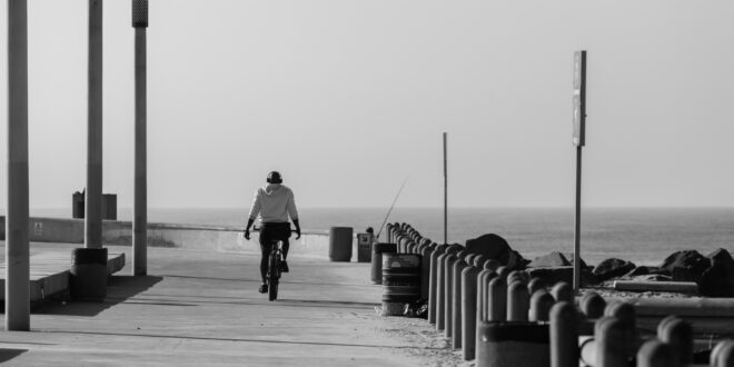 person riding bike on pier