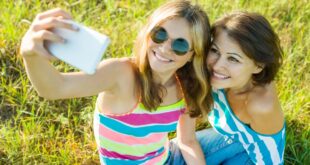 two teenage girls taking a phone selfie