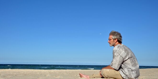 man sitting on beach