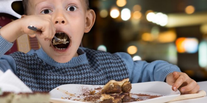 child eating dessert