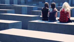 three girls sitting at memorial site