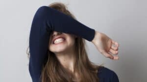 girl with arm over her eyes