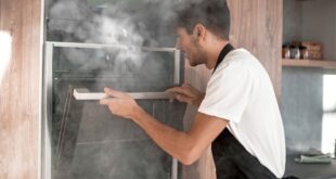 man peering in smoky oven